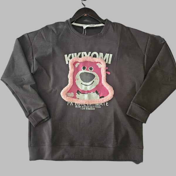 Black sweatshirt with a colorful graphic design on a wooden floor