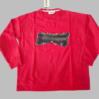 Red t-shirt with a graphic design on a round black table