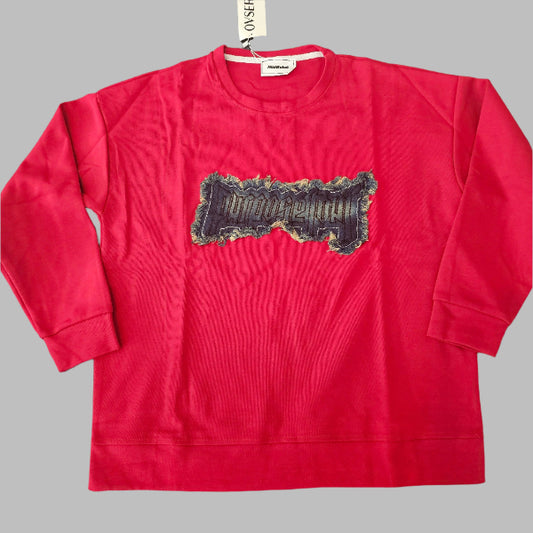 Red t-shirt with a graphic design on a round black table